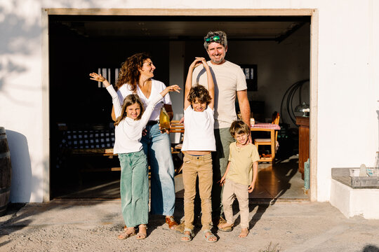 Portrait of a local family standing in front of their wine factory