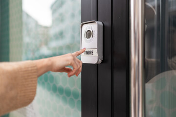 Person ringing the front doorbell.