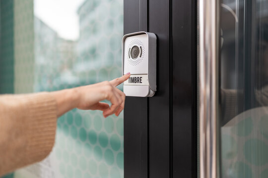 Person ringing the front doorbell.