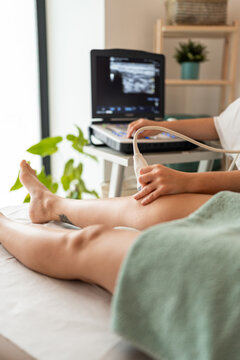 Doctor performing an ultrasound on knee.