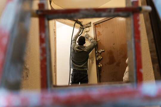 Contractor doing electrical system installation in building