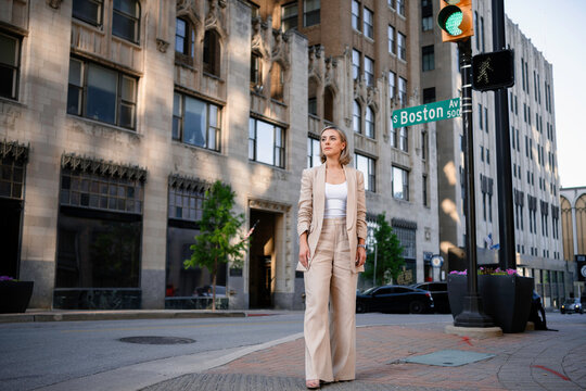 A woman stands on a city street