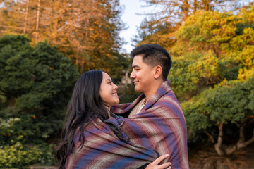 Heartwarming couple in love wrapped in blanket