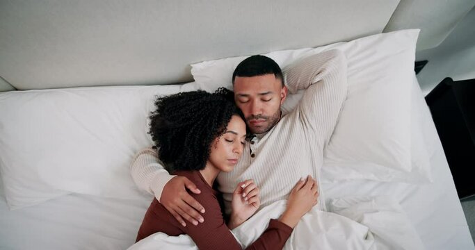 Relax, sleeping and couple with cuddle in bed for rest, blanket and cozy morning in bedroom. Top view, love and tired man with woman on lazy weekend for dreaming, fatigue or comfortable break in home