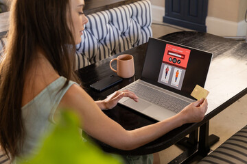 Shopping online, woman using laptop and holding credit card at home