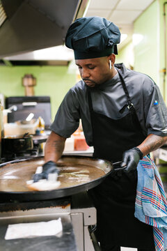 Chef Cleaning Large Pan