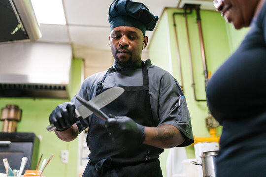 Chef sharpening the knife