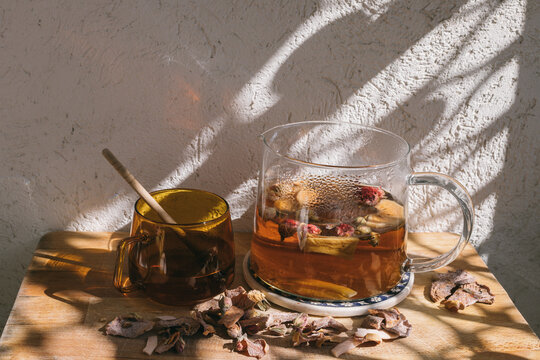 A teapot and a cup with tea on the balcony