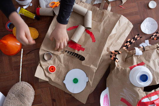 boy create monster mask  from paper bags 