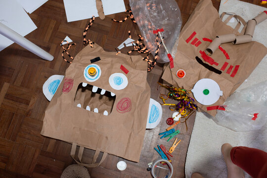 boy create monster mask  from paper bags 