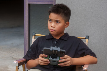 kid plays with drone control