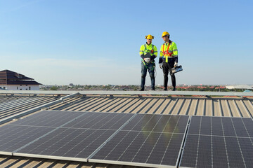 Electrical engineers team inspect solar panel on the building rooftop.