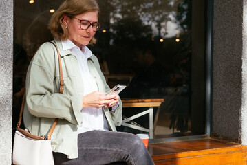 Woman with mobile phone in the street