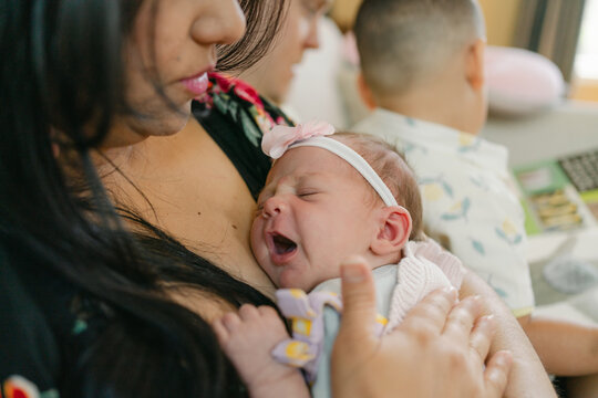 mother affectionately snuggling her newborn 