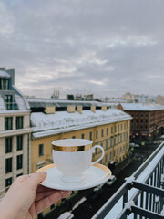 Enjoying a cup of coffee on a cold winter morning on the rooftop in the city