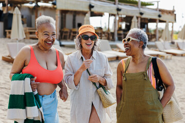 Joyful senior women enjoying a day at the beach