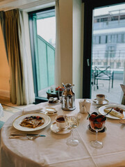 Elegant breakfast scene with pancakes, berries, and fine tableware