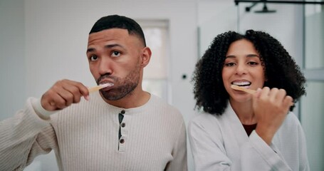 Face, couple and brushing teeth together for hygiene with gum health, bonding and morning grooming in home. Woman, man and tooth cleaning in bathroom for dental wellness, mouth care and fresh breath