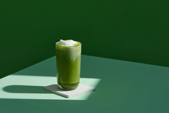 iced matcha latte green tea on green background