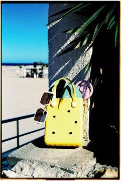 summer items in a yellow plastic bag, 35mm film