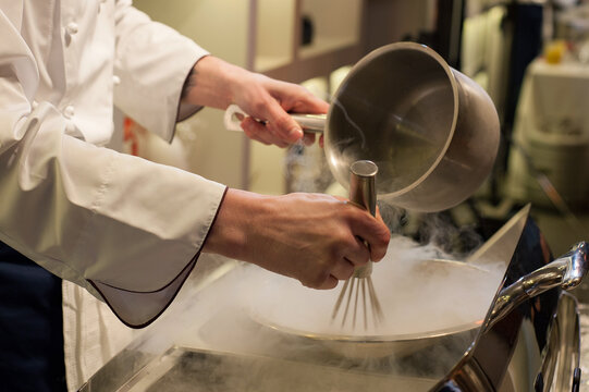 Chef preparing ice-cream with a liquid nitrogen