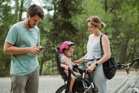 Young family with a kid during a bike ride in the forest
