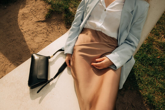 Midsection of a woman in stone deckchair