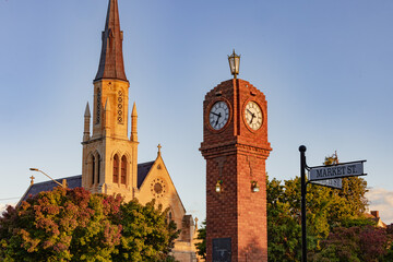 The iconic clock tower in the middle of roundabout at Mudgee with Church in background