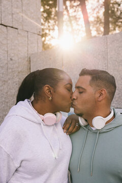 Curvy Dominican couple sharing a tender moment at sunset