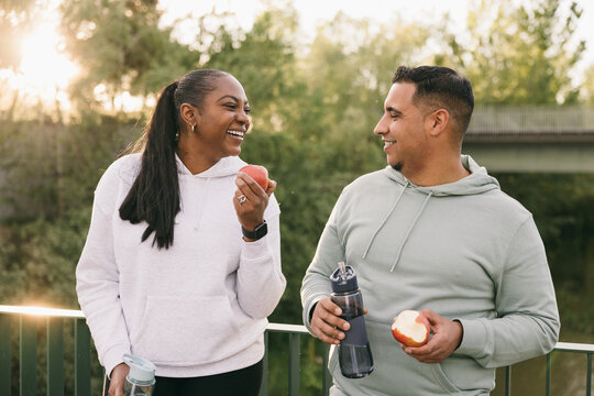 Smiling Dominican couple sharing a healthy moment outdoors