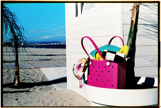 pink plastic bag with summer objects, 35mm film