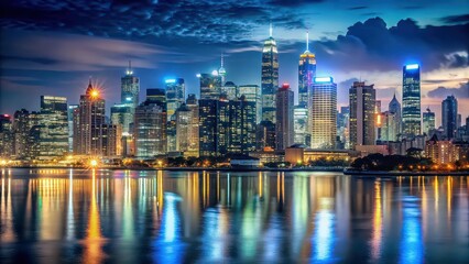 Naklejka premium Night view of city skyline with illuminated buildings and glowing lights, cityscape, night time, skyline
