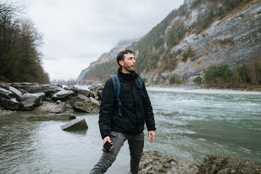 Hiker Exploring Mountain River