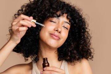 Woman enjoying aromatherapy with essential oil dropper