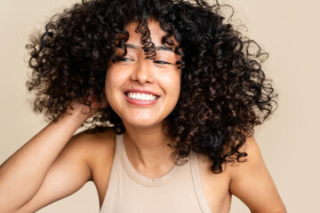 Radiant smile - joyful woman with curly hair