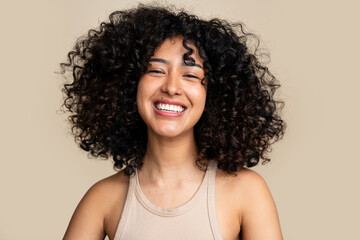 woman with curly hair laughing joyously