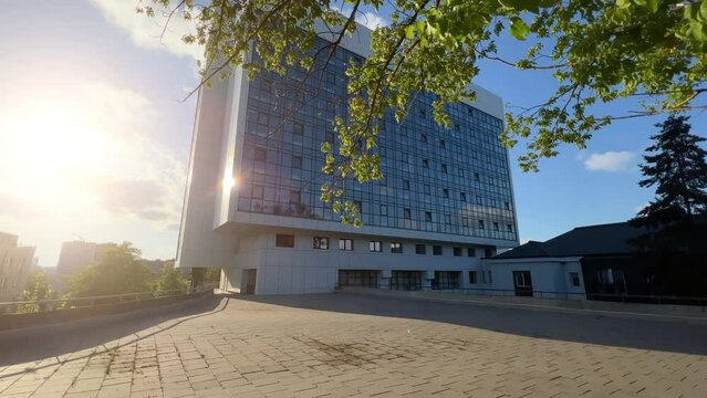 Modern Hospital Building. Establishing Shot: Ultrawide Sunlit Exterior | Innovative Healthcare Clinic with Lens Flare and Glass Facade