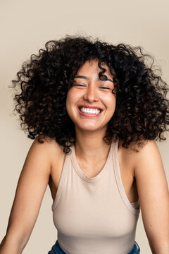 woman with curly hair smiling