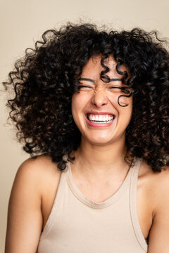 woman laughing with eyes closed