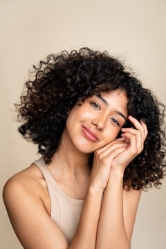 Joyful woman with curly hair posing