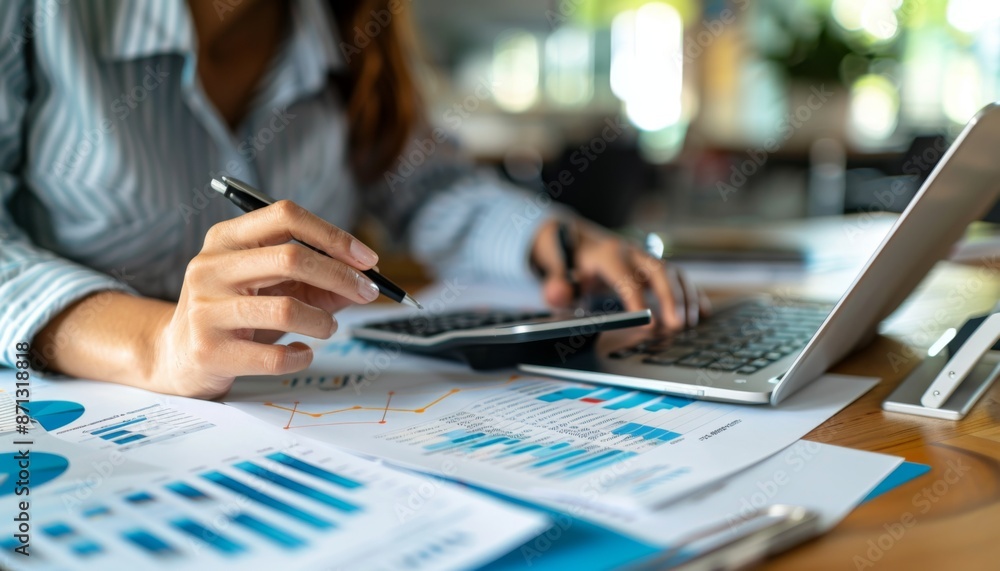 Poster close-up of accountant using calculator while examining report