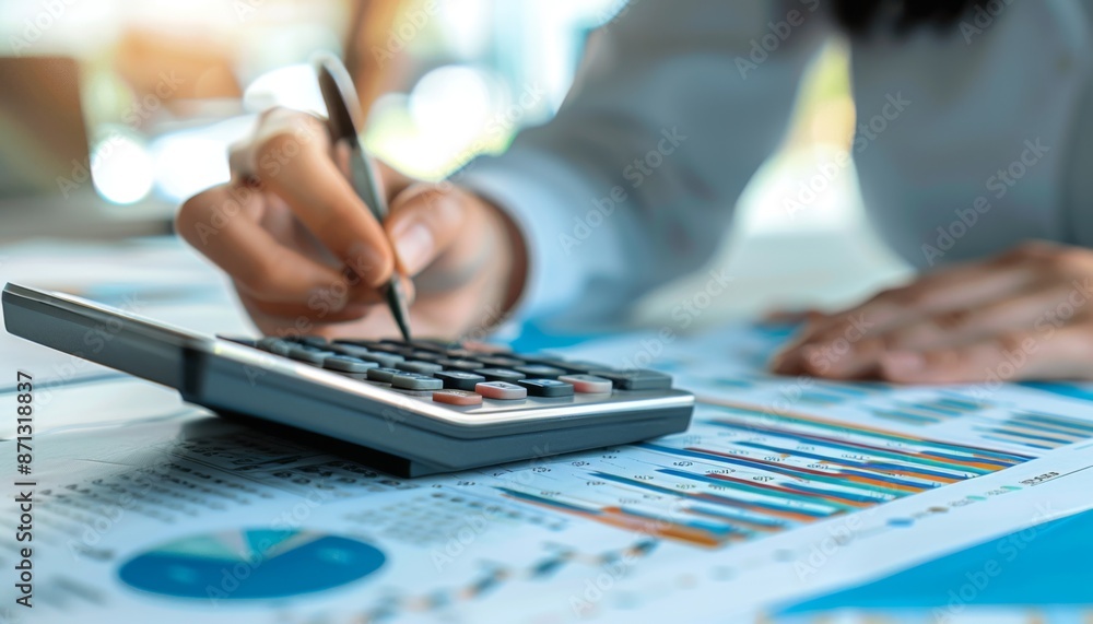 Aufkleber close-up of accountant using calculator while examining report