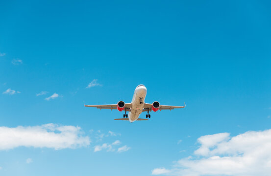 Airplane take off in bright blue sky