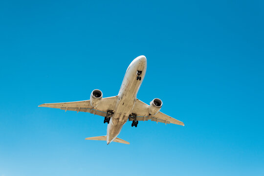 Airplane flying in clean blue sky 