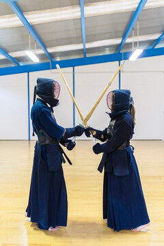 Kendo Practitioners Facing Off in Dojo