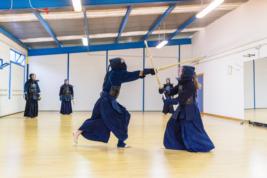 Kendo Practitioners Sparring in Dojo