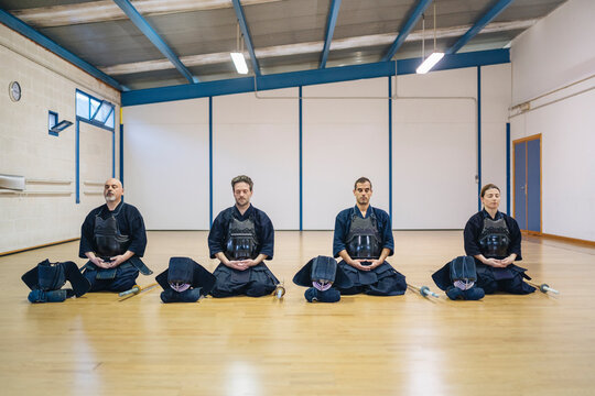 Kendo Practitioners Meditating in Dojo