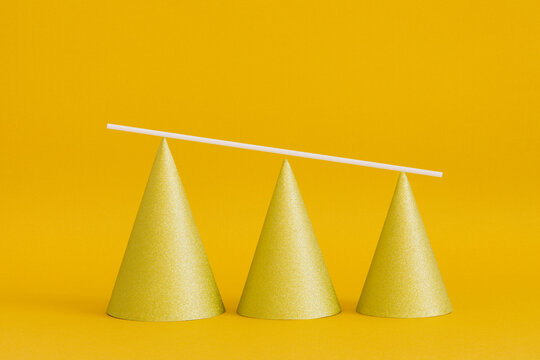 Shiny golden pyramid cones aligned according to height