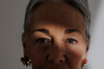 Serene mature woman with subtle smile in studio