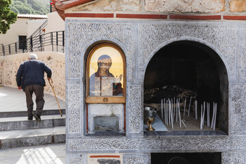 Votive candles near an icon of the Virgin Mary